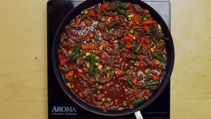 Ground Beef and vegetables simmering with sauce for Shepherd's Pie Filling