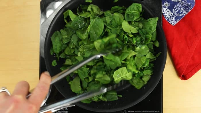 Saute the spinach in a skillet