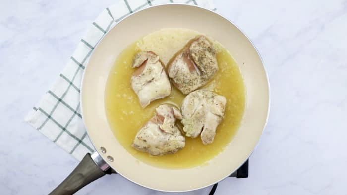 Add chicken broth to skillet and simmer until chicken is cooked through