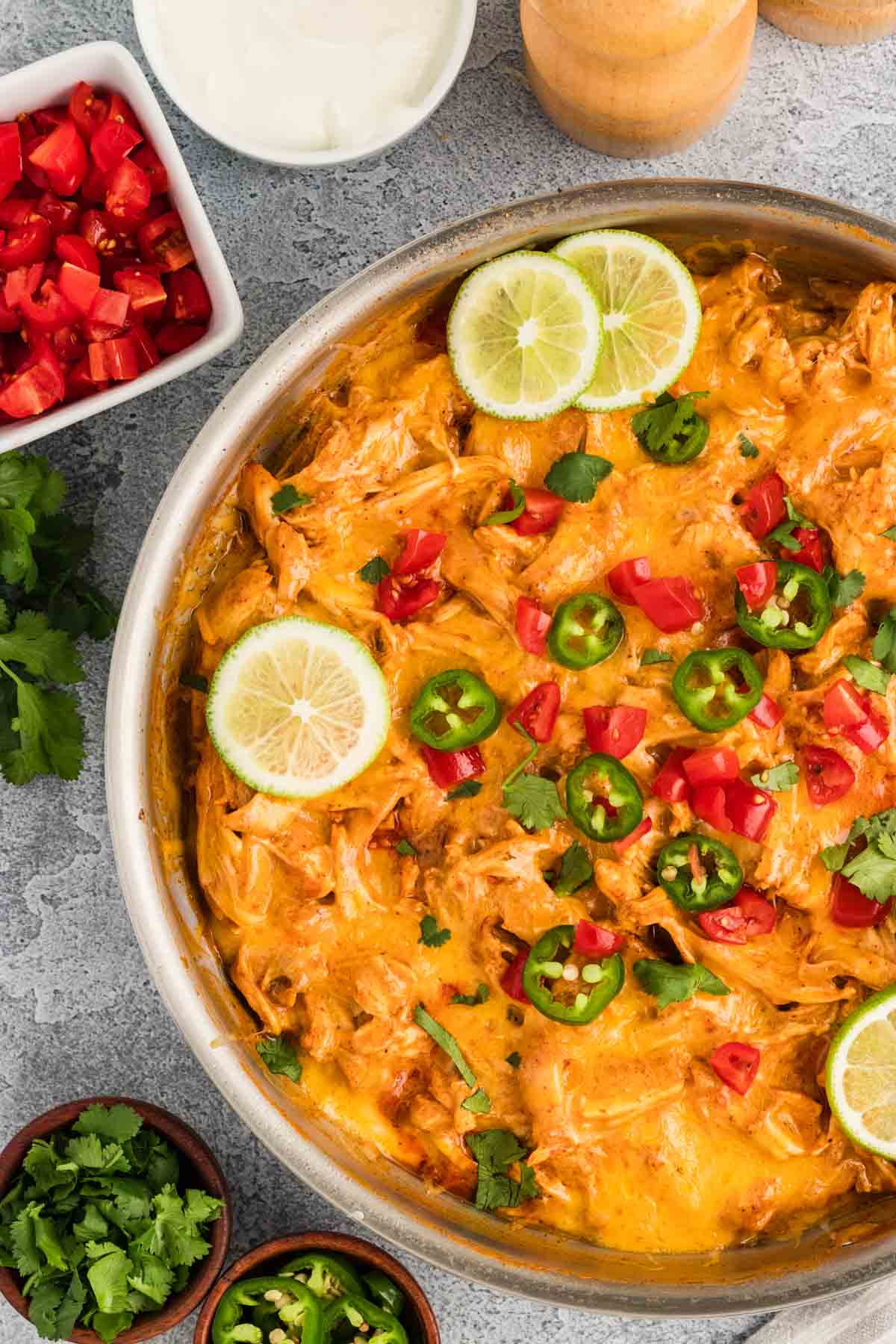 Overhead view of chicken enchilada skillet dinner topped with jalapenos and tomatoes