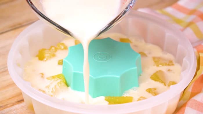 Pour ice cream jello into mols with cubes of orange gelatin