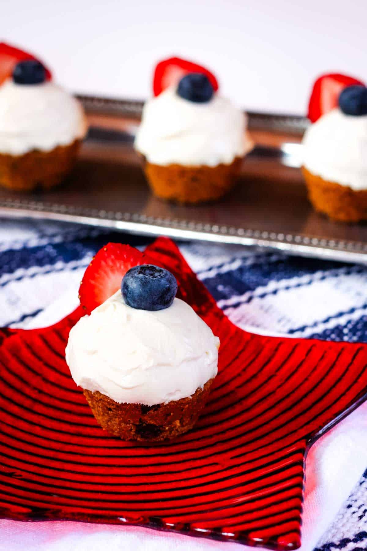 A berry cookie cup on a red plate
