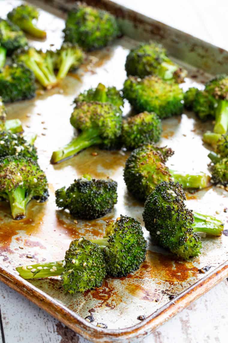 A sheet pan of roasted broccoli with sesame seeds and soy sauce maple syrup glaze