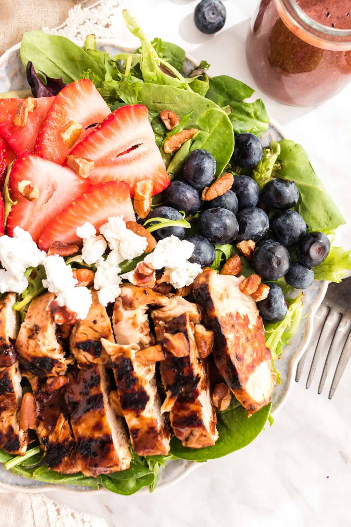 Overhead of Grilled Chicken Salad with berries and goat cheese