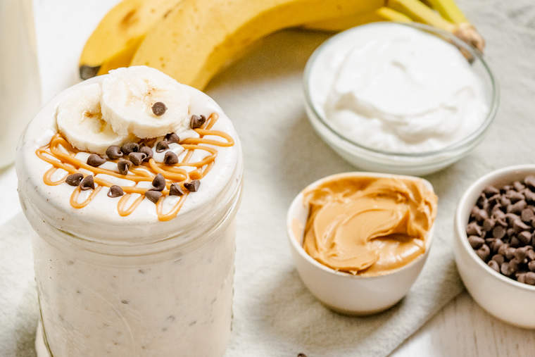 Chocolate Chip Banana Peanut Butter Banana Smoothie with ingredients in the background