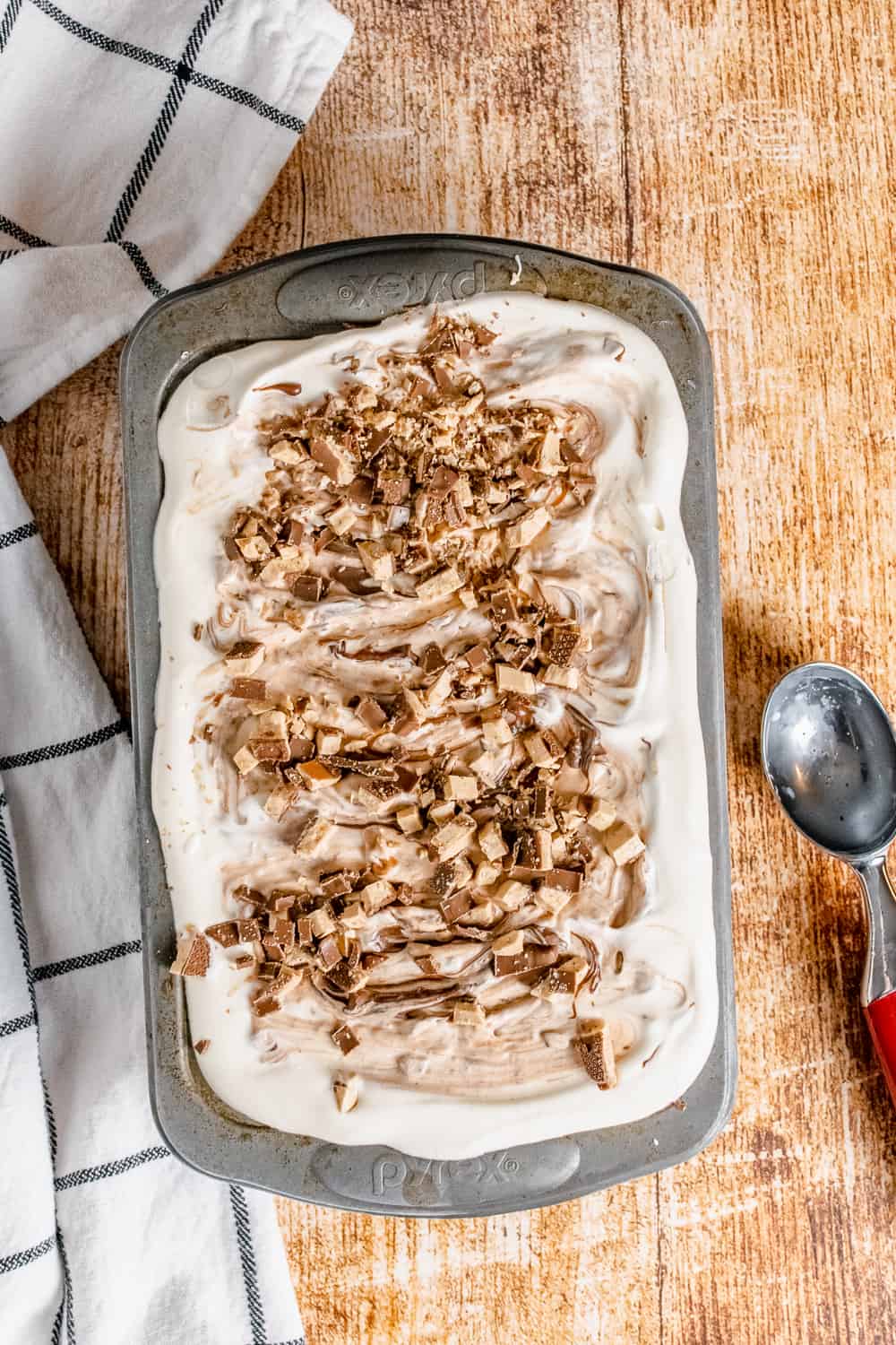 No-Churn Ice Cream Swirled with Nutella and Heath Bar bits in a metal loaf pan.