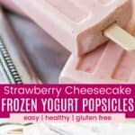 A closeup of a wooden stick in the bottom of one pink popsicle and several piled on a silver platter and one being held up divided by a pink box with text overlay that says "Strawberry Cheesecake Frozen Yogurt Popsicles" and the words easy, healthy, and gluten free.