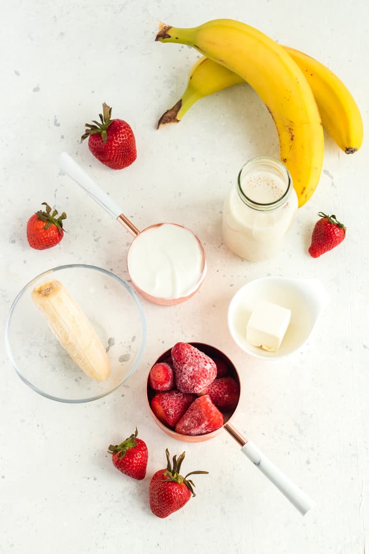 Table with ingredients to make a Strawberry Cheesecake Smoothie