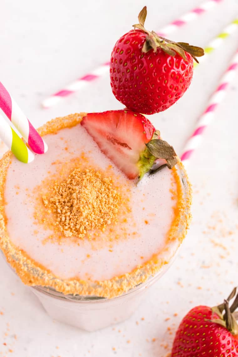 Top of a Strawberry Cheesecake Smoothie in a glass garnished with graham cracker crumbs