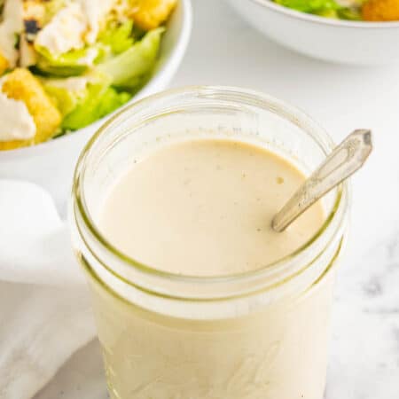 A mason jar of Greek yogurt Caesar salad dressing.