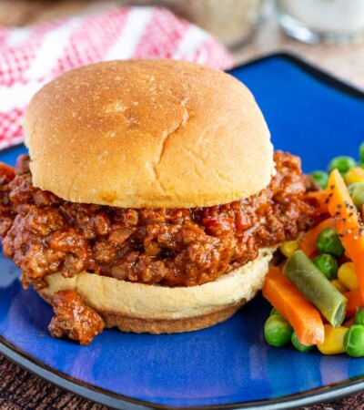 Easy sloppy joe on a blue plate with vegetables