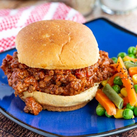 Easy sloppy joe on a blue plate with vegetables