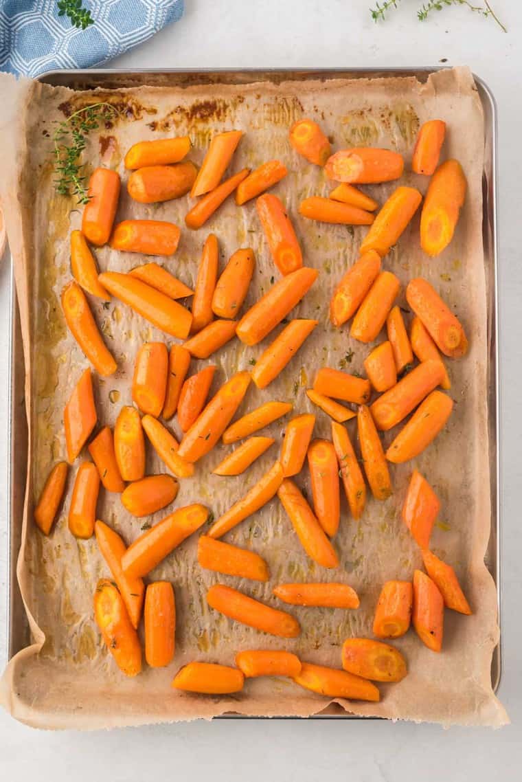 roasted carrots baked on a sheet pan with parchment paper