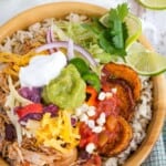 A Mexican chicken and rice bowl with toppings with text overlay that says "Chicken Burrito Bowls".