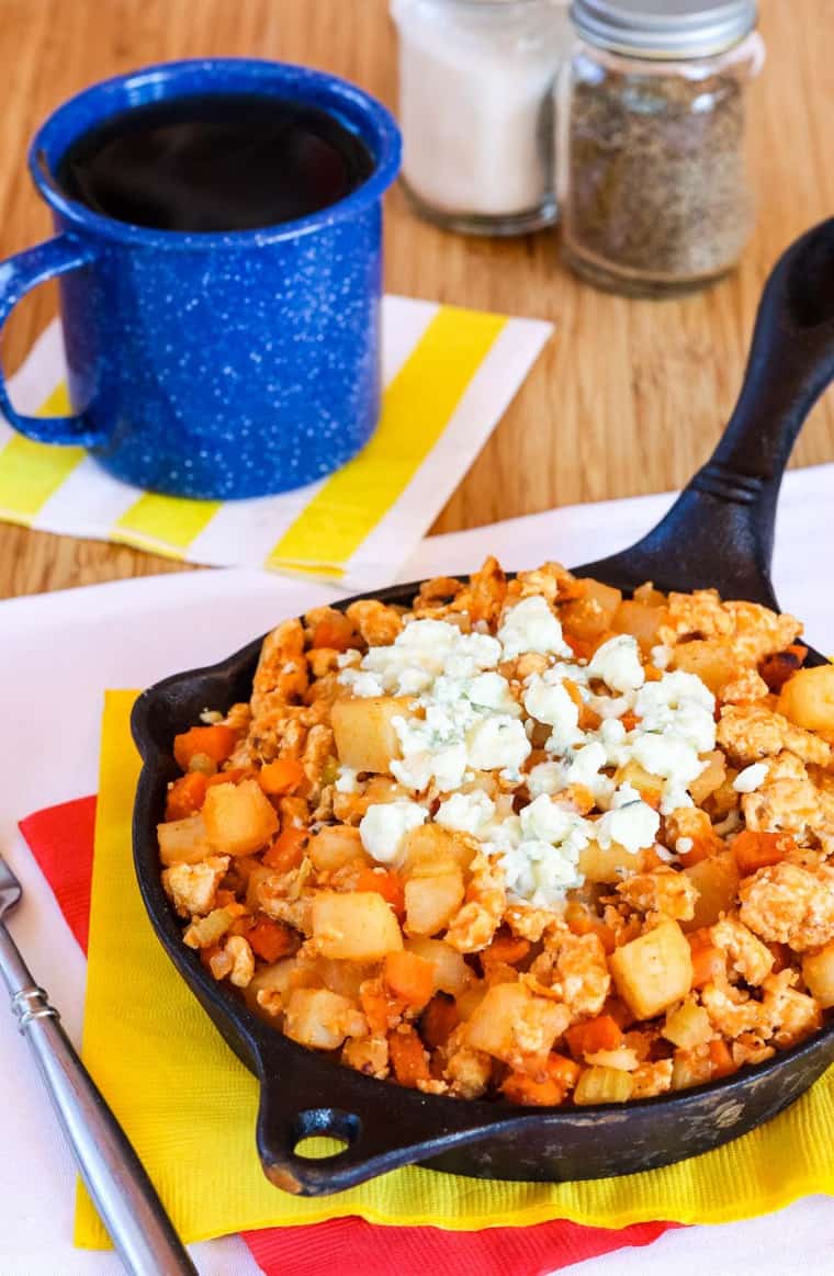 Spicy Ground Chicken Hash in a cast iron skillet topped with blue cheese