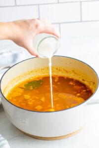 pouring the cornstarch slurry into the pot