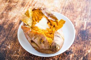 Baked Sweet Potato with butter on a plate