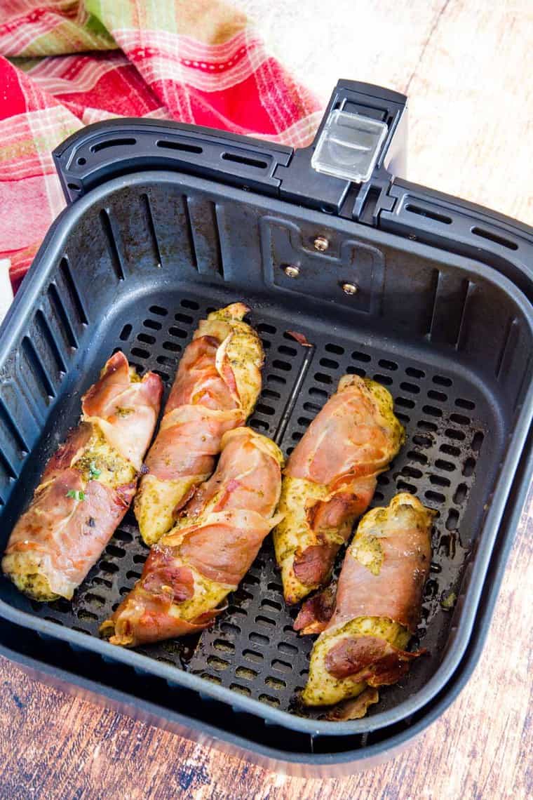 Chicken tenders in an air fryer basket