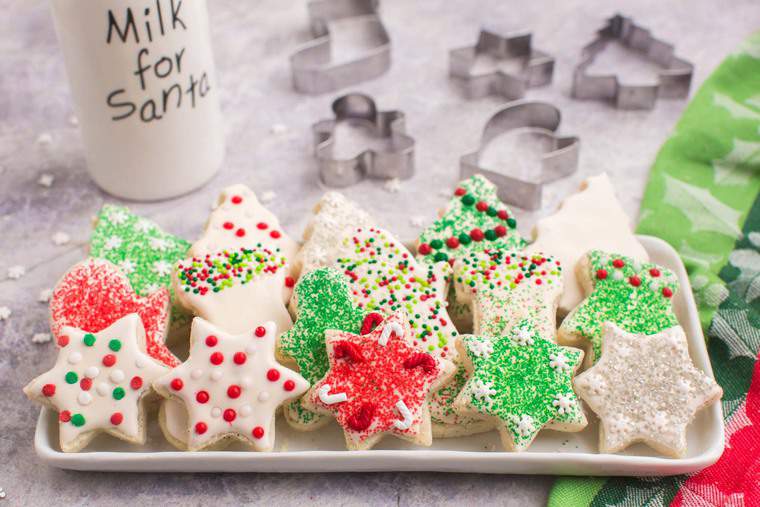 Cookies in the shapes of stars. stockings, and Christmas trees on a rectangular platter