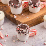 hot cocoa marshmallows and snowman marshmallows on a marble table and wooden serving platter