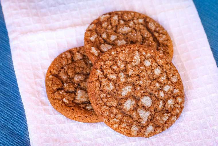 Three gingersnaps on a white napkin