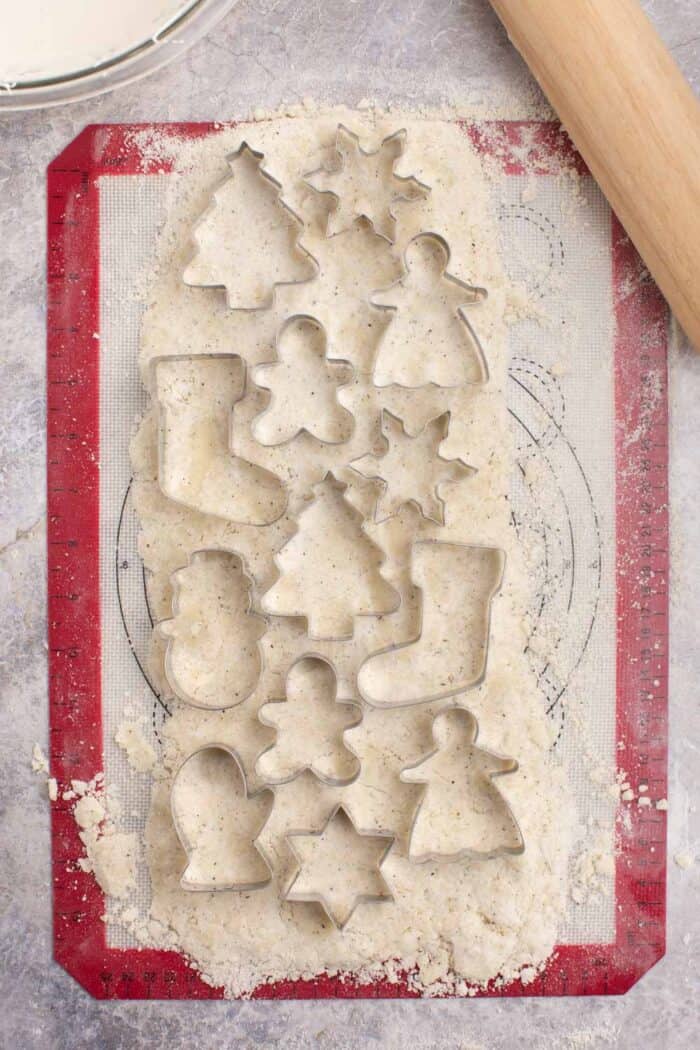 Cookie cutters laying on top of rolled out cookie dough