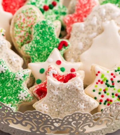 Cookies in the shapes of stars. stockings, and Christmas trees on a fancy serving tray