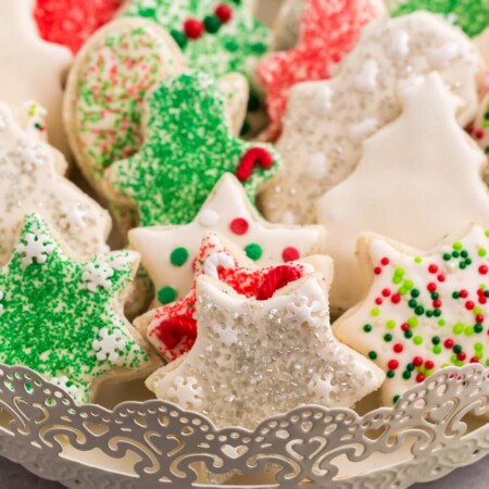 Cookies in the shapes of stars. stockings, and Christmas trees on a fancy serving tray