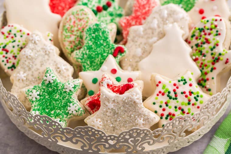 Cookies in the shapes of stars. stockings, and Christmas trees on a fancy serving tray