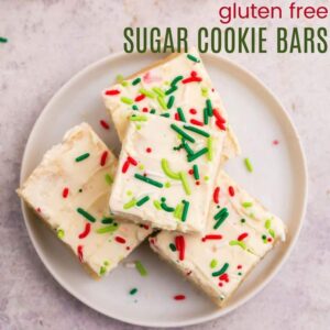 Four gluten free sugar cookie bars on a small white plate