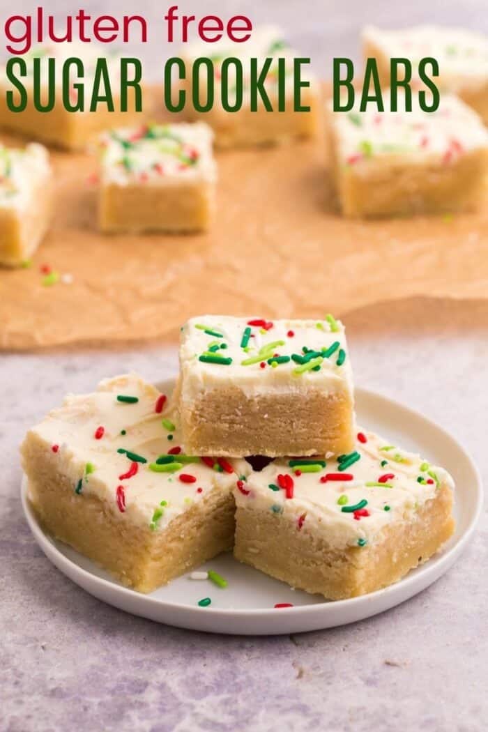 Three gluten free sugar cookie bars in a pyramid on a white plate
