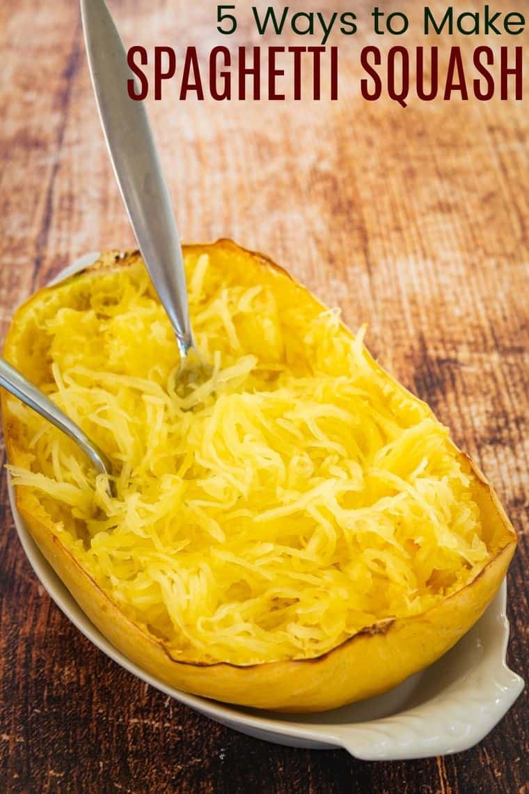 Half of a spaghetti squash scraped into noodles with two forks in it