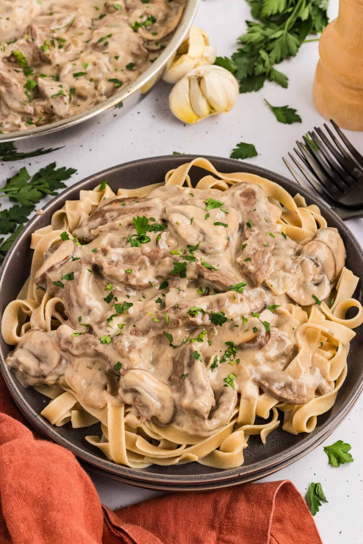 Overhead view of a plate of beef stroganoff over egg noodles
