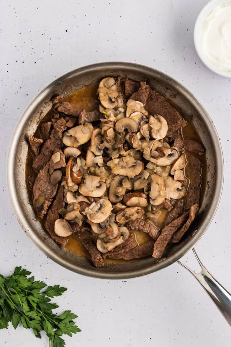 Cooked mushrooms added to the pan