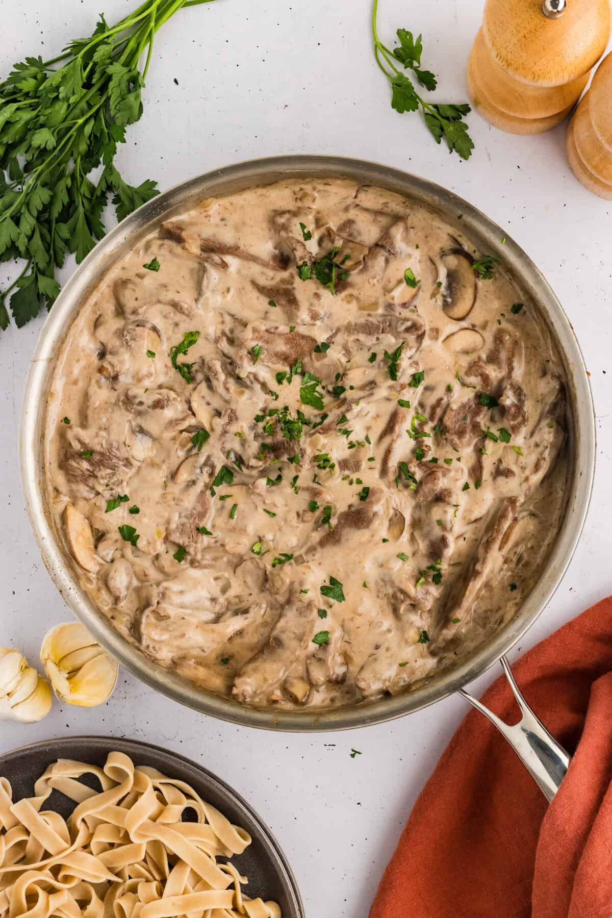 Beef stroganoff topped with parsley in a pan