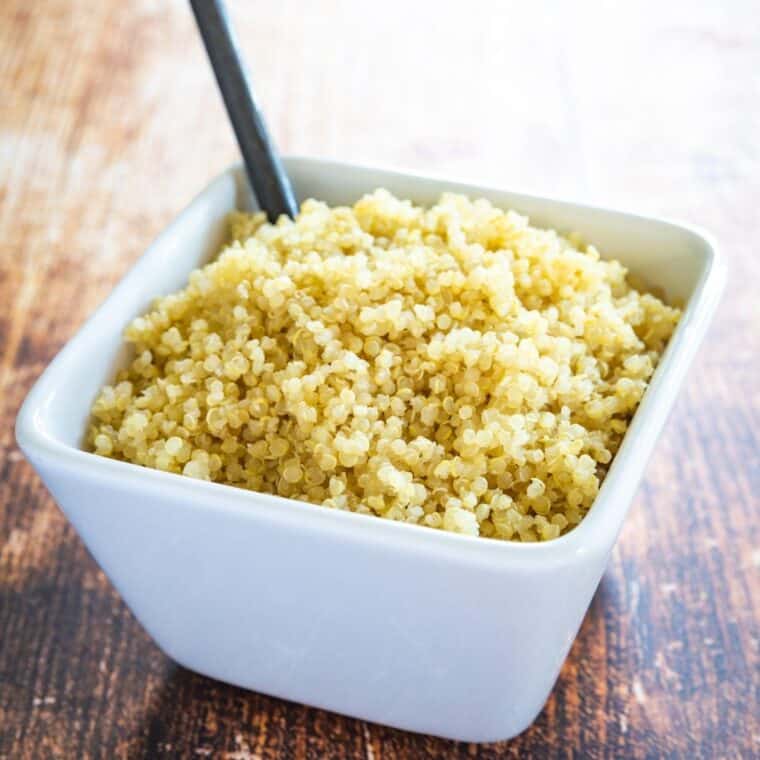 Cooked quinoa in a white square-shaped bowl