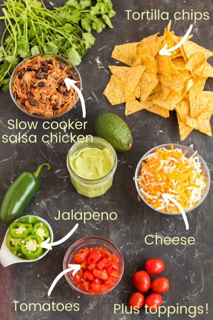 Ingredients to make sheet pan chicken nachos on a slate tabletop