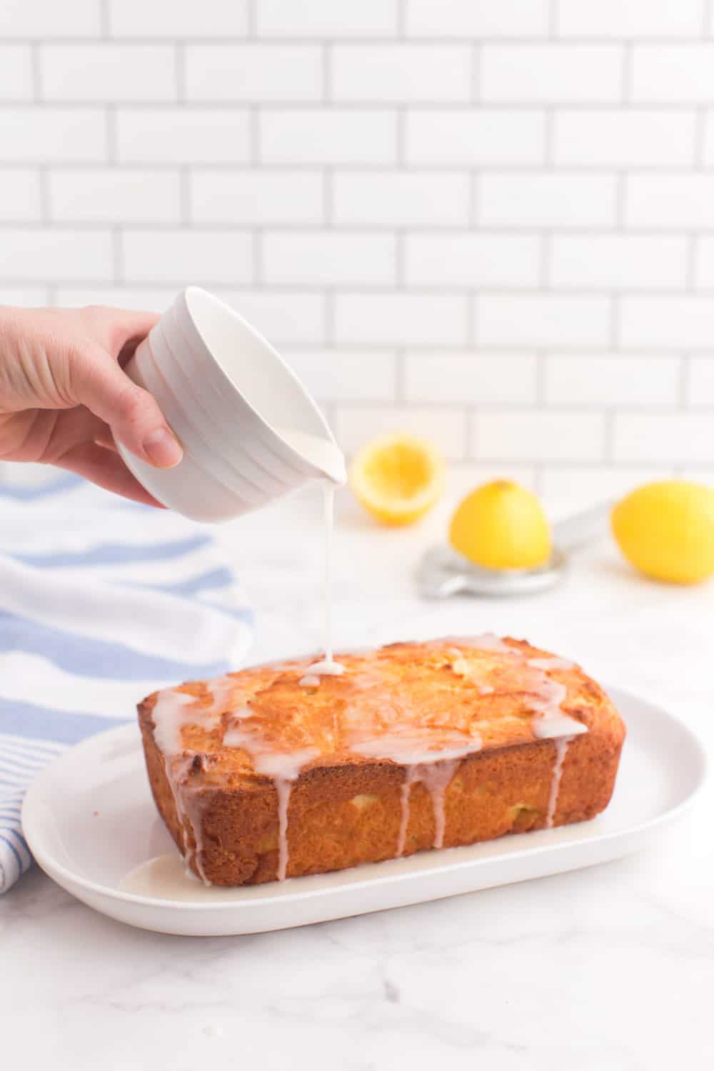 Pouring glaze over the baked loaf.