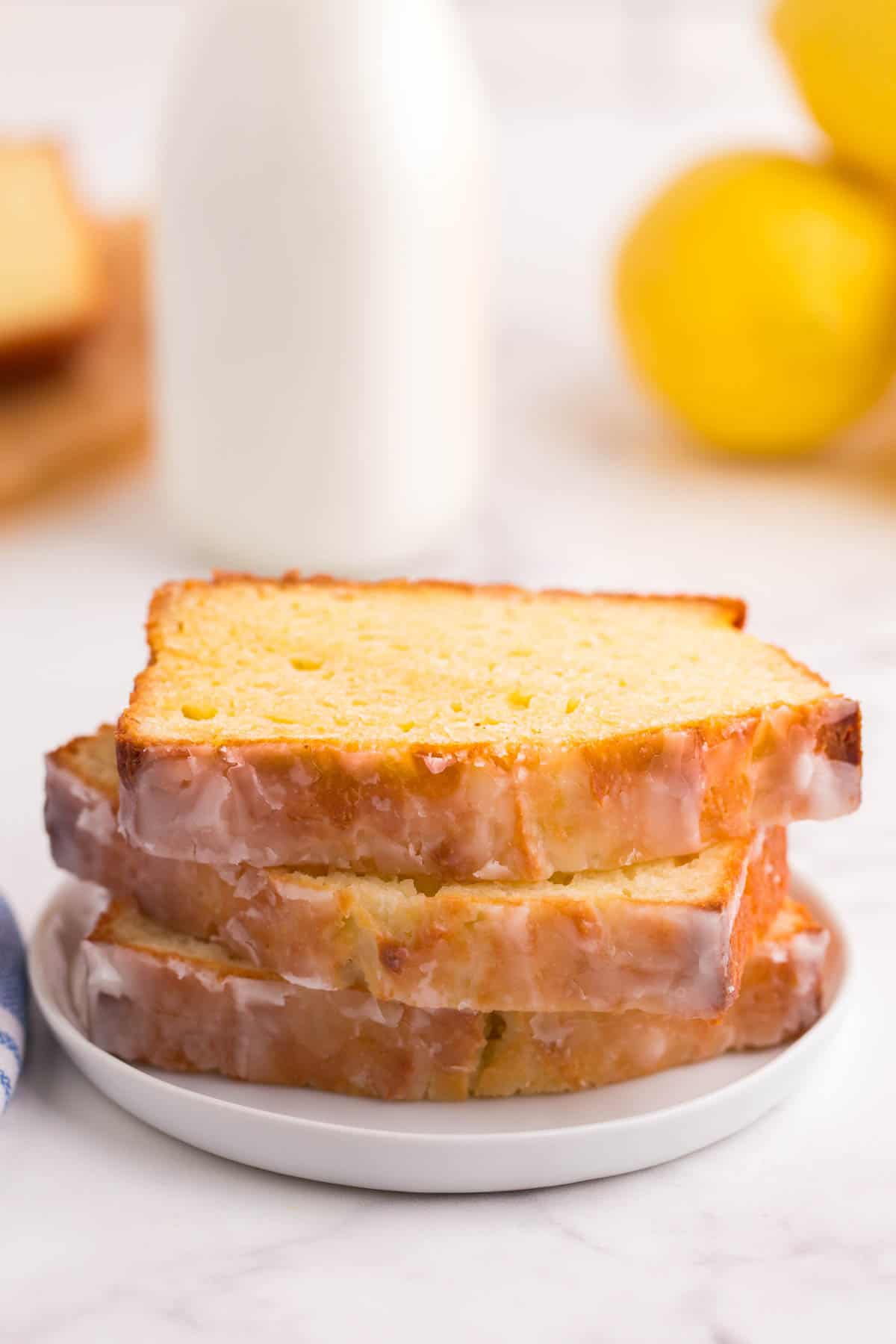 Three stacked slices of the loaf on a small white plate.