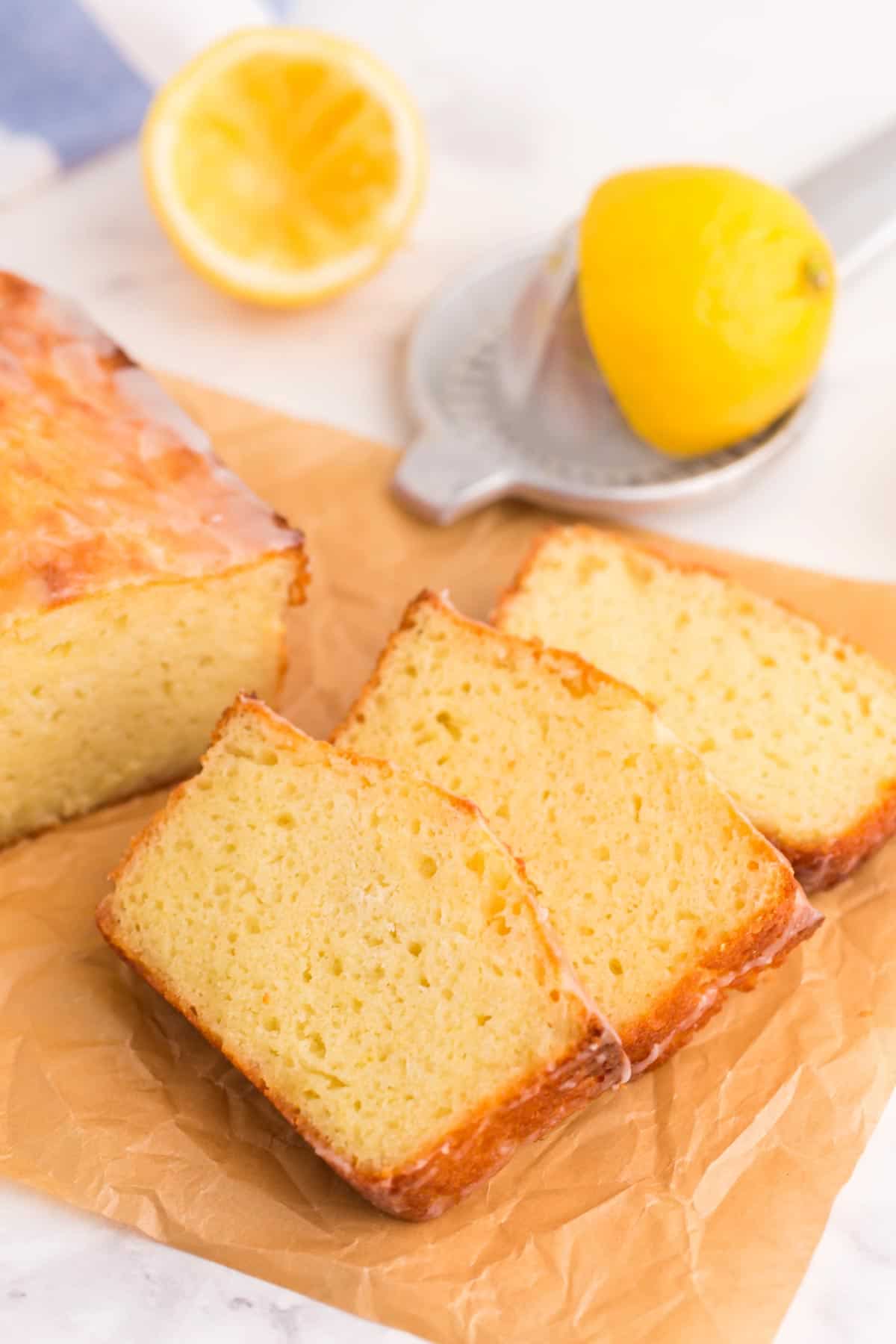 Three slices of pound cake on a piece of parchment paper.