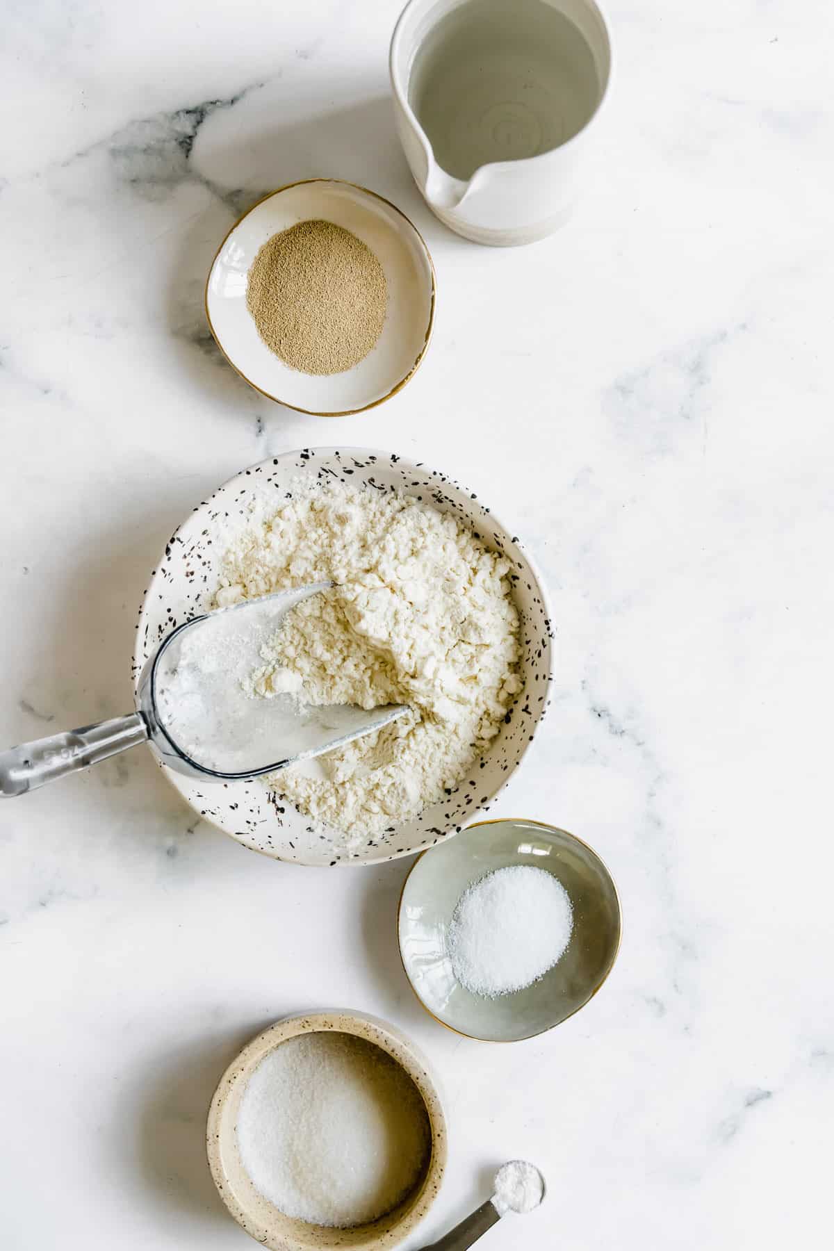 Salt, Gluten-Free Flour, and the Rest of the Pizza Dough Ingredients on a Countertop