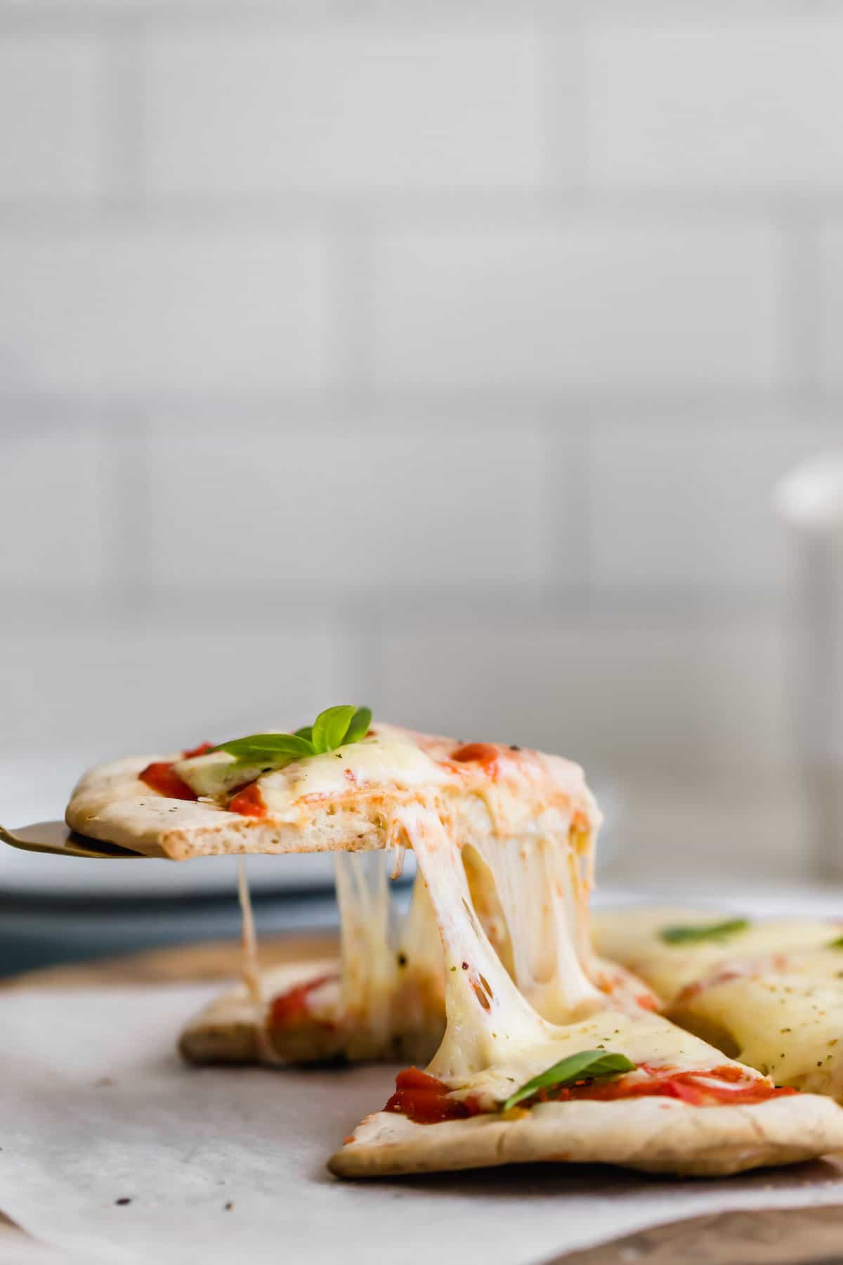 A Slice of Gluten-Free Pizza Being Lifted with a Metal Spatula