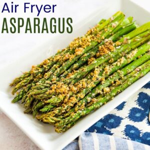 cooked asparagus with parmesan cheese crust on a white rectangular plate