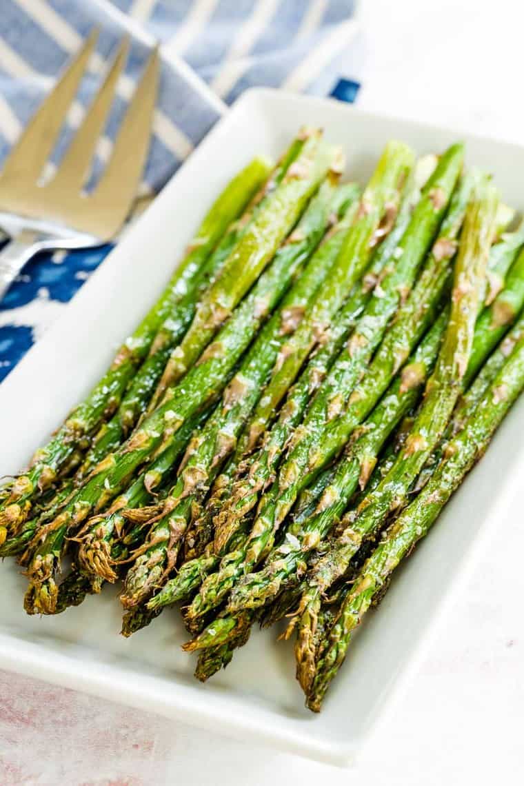 simple air fryer roasted asparagus on a white rectangular plate