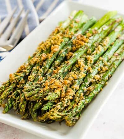 air fryer asparagus with parmesan cheese crust on a white rectangular plate