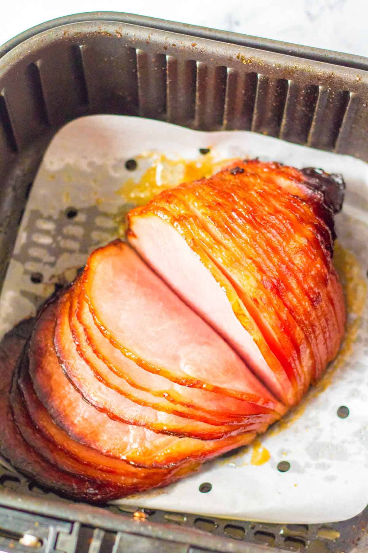 cooked ham in an air fryer basket