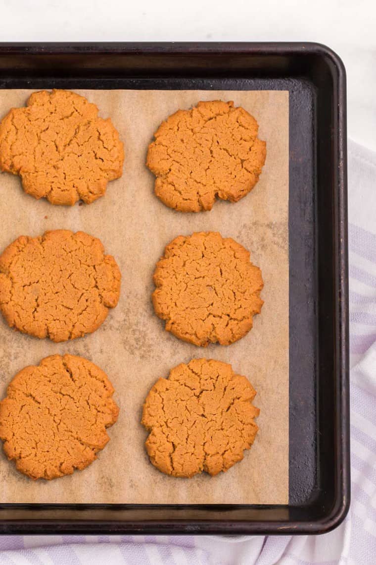 flourless peanut butter cookies on parchment paper on a baking sheet