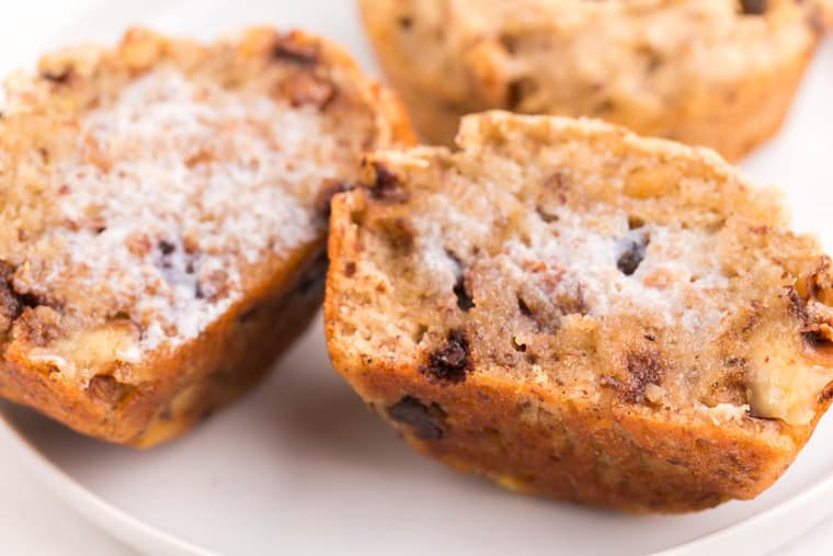 Butter melting into the crevices of a warm gluten free banana muffin cut in half