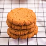 four stacked cookies on a cooling rack