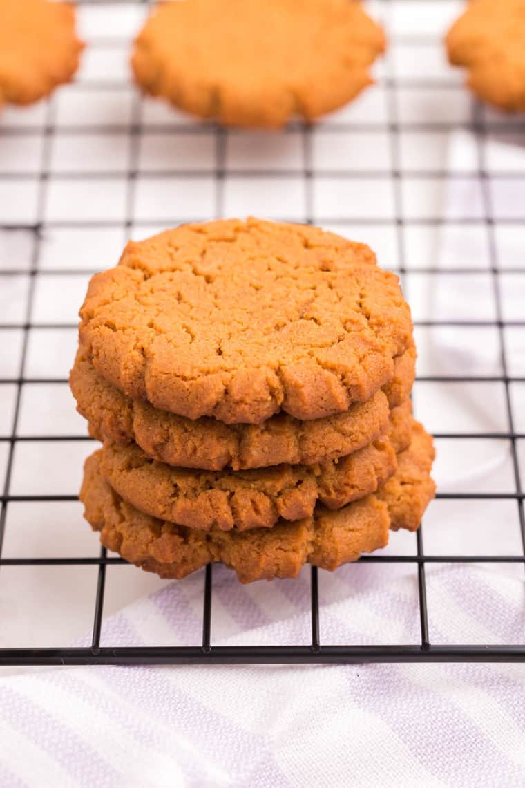 four stacked cookies on a cooling rack